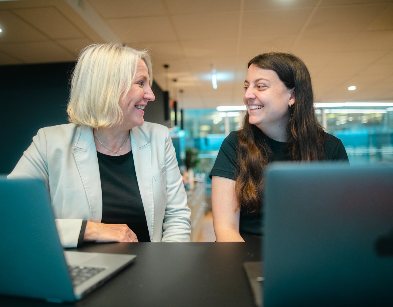 Two women smiling at each other